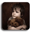 Scared looking child holding a teddy bear