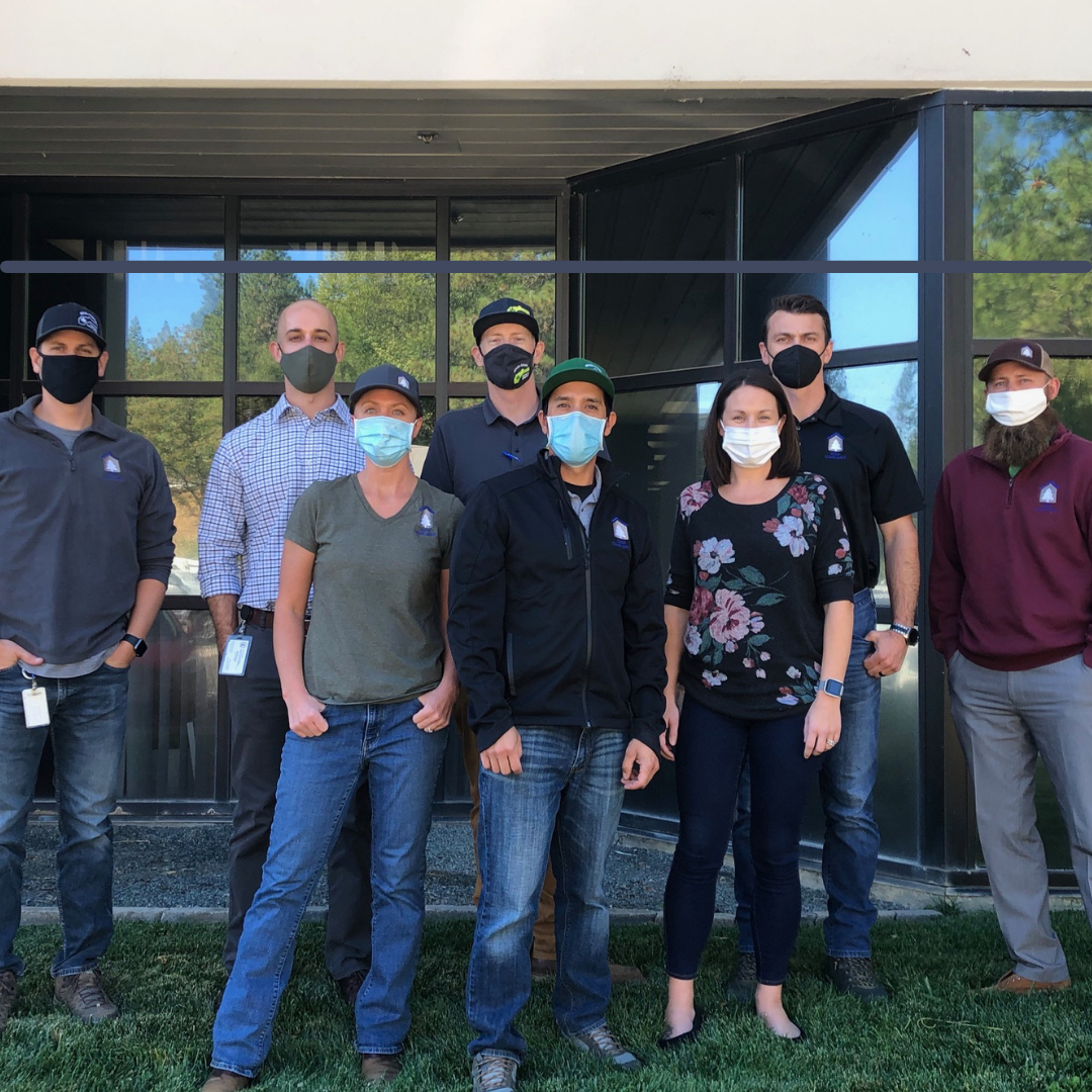 Code Compliance Staff group photo with masks on outside the Rood Center. 