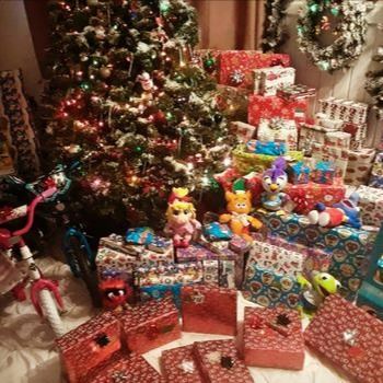 Many wrapped presents under a decorated Christmas Tree