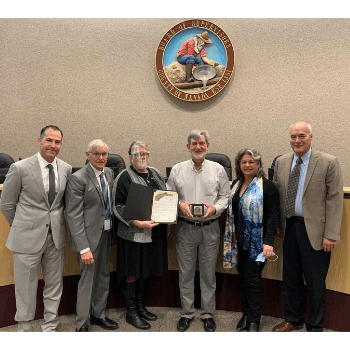 Dr. Van Houten Receiving Certificate of Recognition from the Board