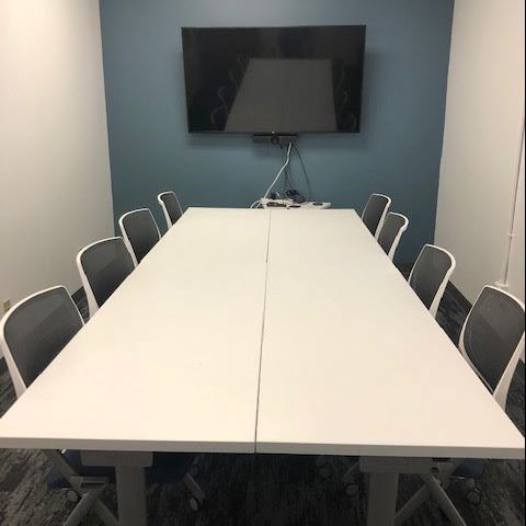Image of Truckee Library Workspace, a conference room with tables, chairs and a 65" flatscreen