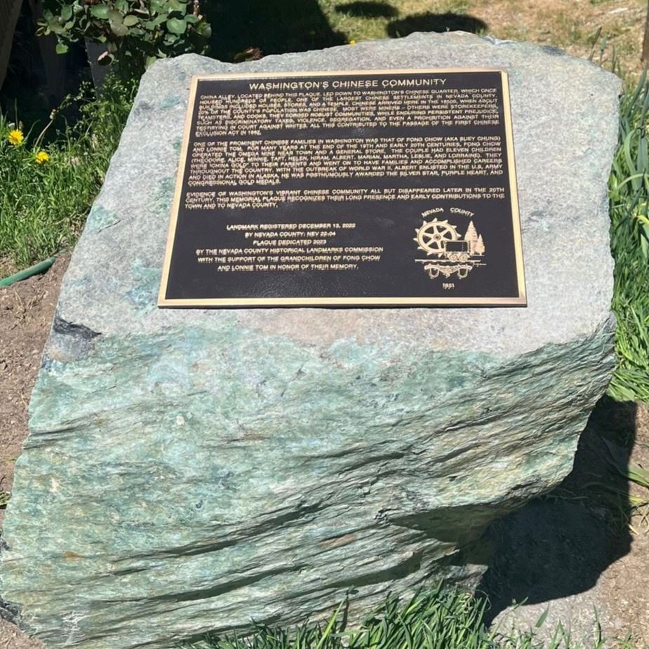 A bronze plaque on a large piece of serpentine stone