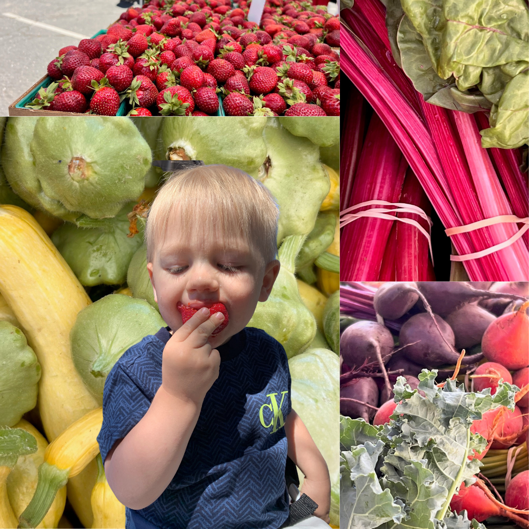National Farmers Market Week Small child enjoying a strawberry with colorful vegetables background