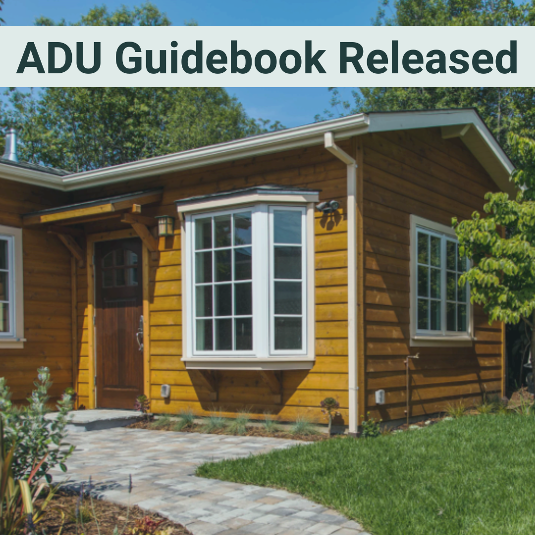 ADU Guidebook Released, woodsided ADU with white trim and path leading to home