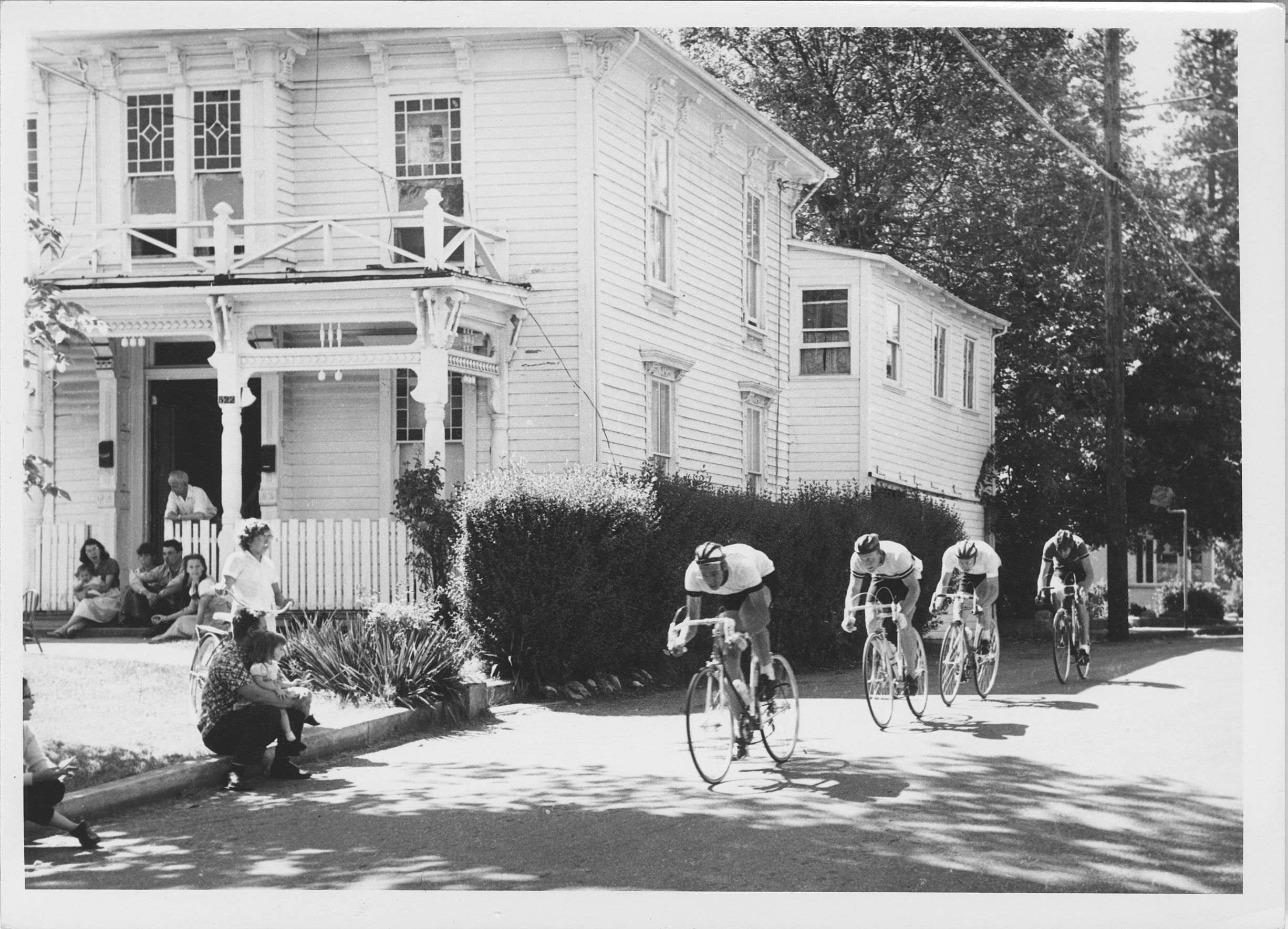 bicycle racers group racing down broad street in downtown nevada city