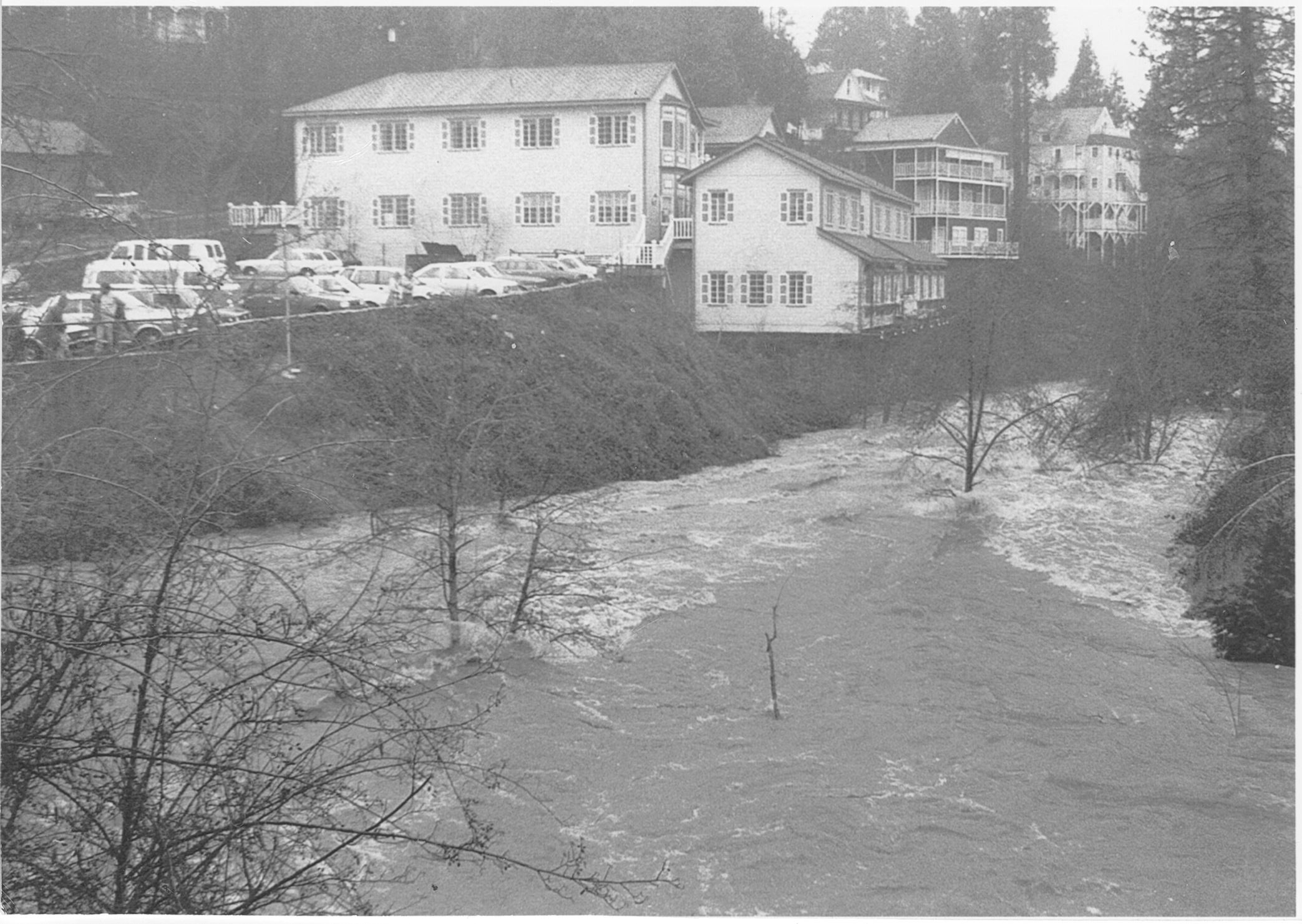 water in a creek rushing past historic buildings