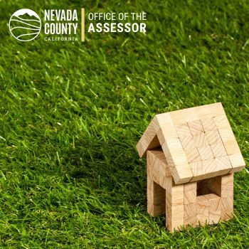 Small brown house on green grass