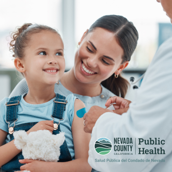 Image of child sitting on mothers lap while getting vaccinated 