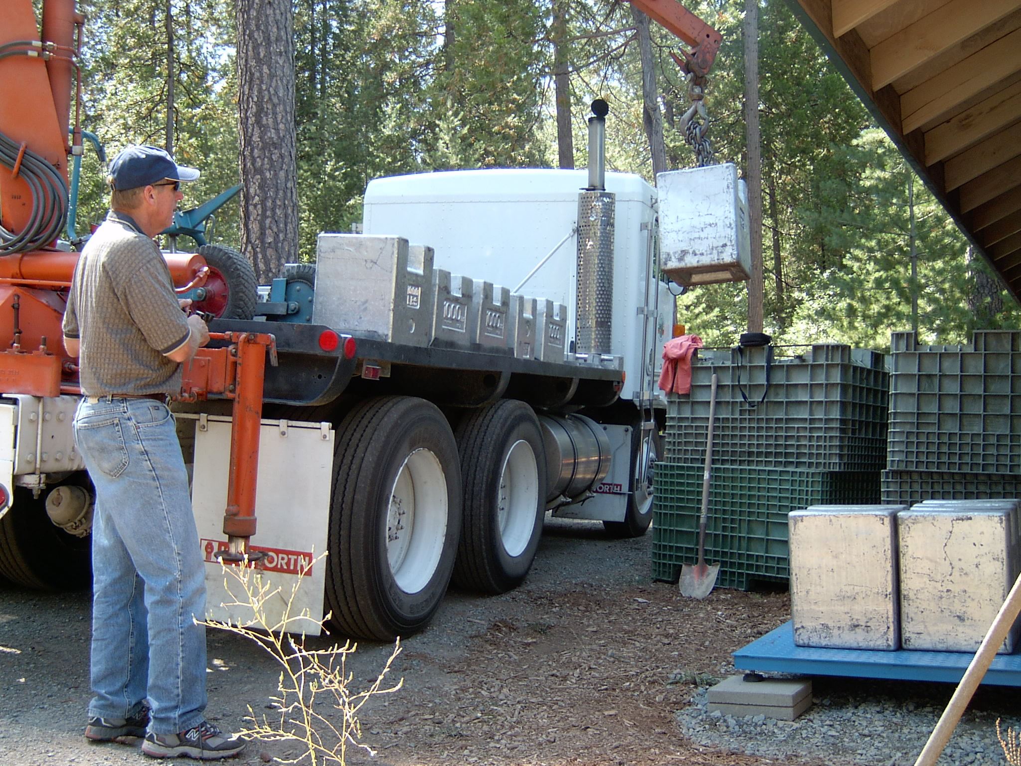 Weight truck  loading 1,000 pound weights with a crane