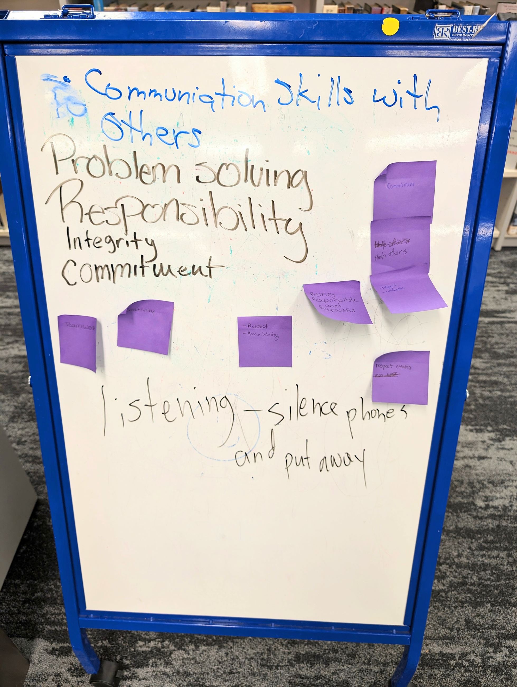 White board marked with words about leadership skills. 