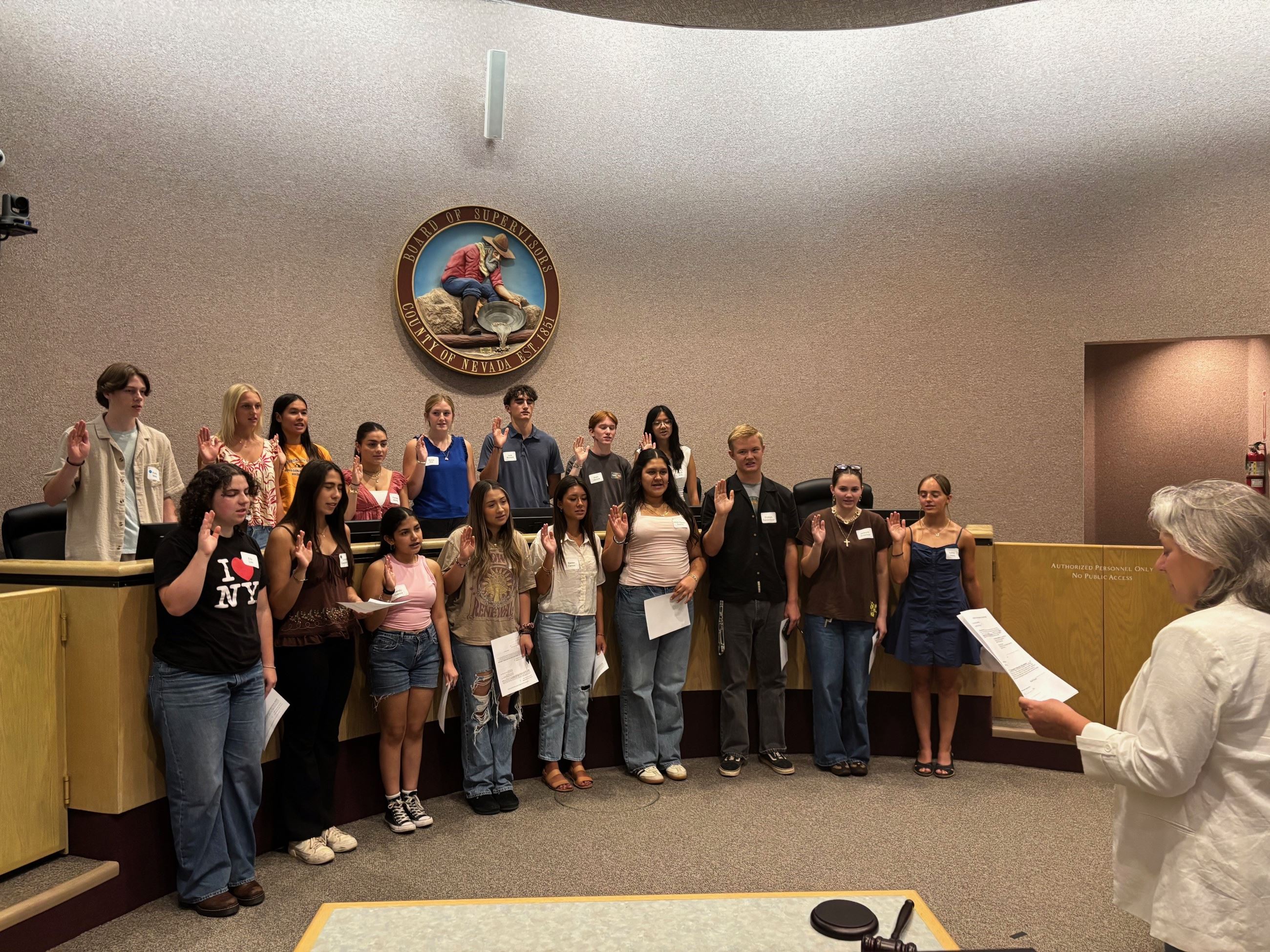 Supervisor Heidi Hall swearing in a group of Youth Commissioners on August 11, 2025